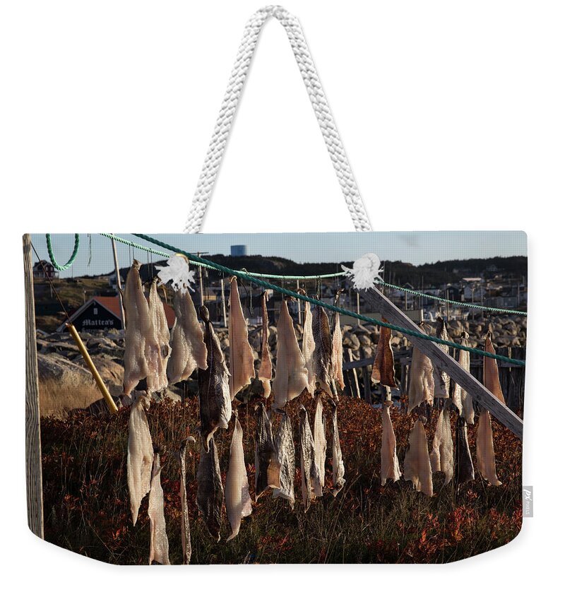 Bonavista Weekender Tote Bag featuring the photograph Drying pieces of salt cod in Bonavista, NL, Canada by Karen Foley