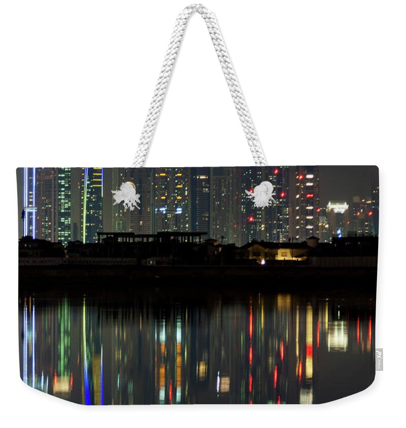 Dubai Weekender Tote Bag featuring the photograph Dubai city skyline nighttime by Andy Myatt