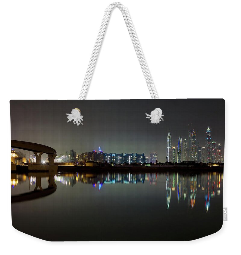 Dubai Weekender Tote Bag featuring the photograph Dubai city skyline night time reflection by Andy Myatt