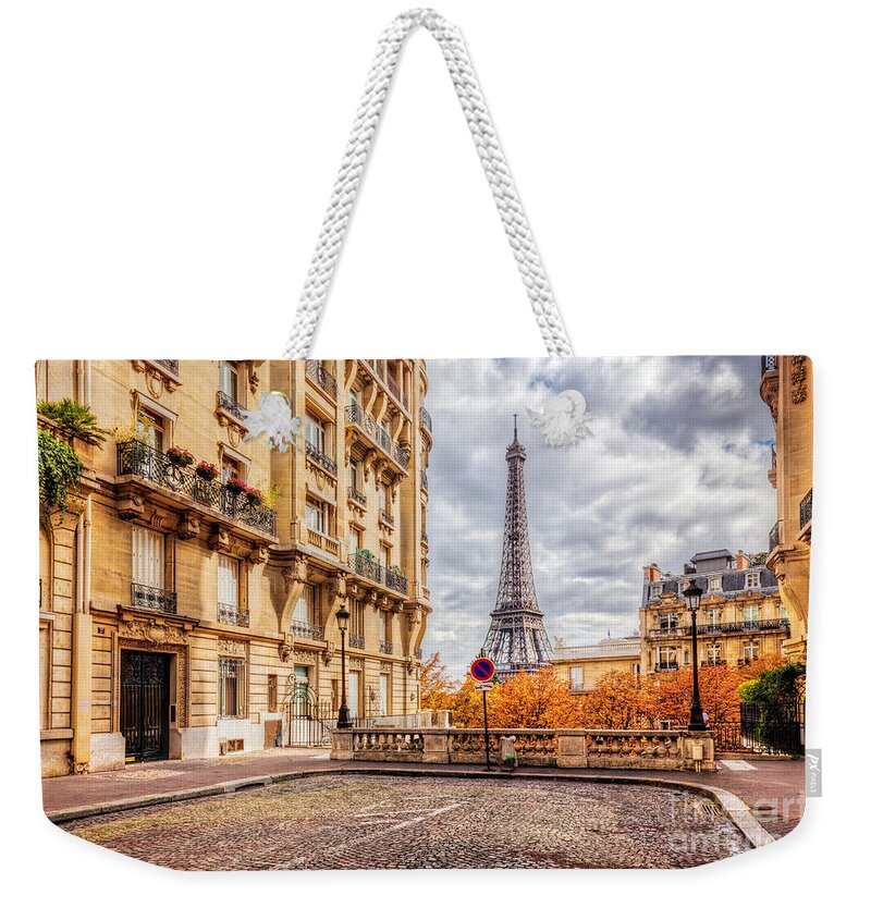 Paris Weekender Tote Bag featuring the photograph Eiffel Tower seen from the street in Paris, France. Cobblestone pavement by Michal Bednarek