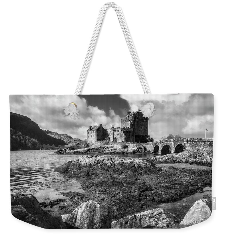 Eilean Donan Weekender Tote Bag featuring the photograph Eilean Donan Castle in black and white by Holly Ross