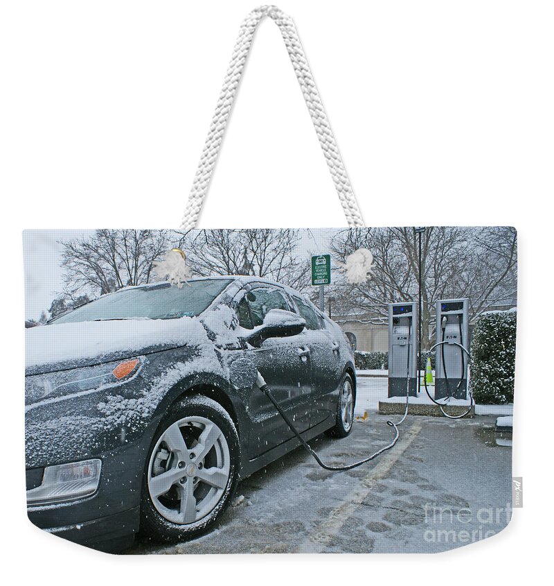 Electric Car Weekender Tote Bag featuring the photograph Electric Car At Recharging Station by Blair Seitz