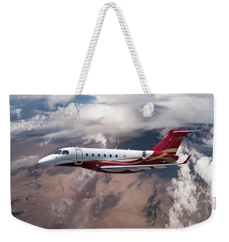 Embraer Aircraft Weekender Tote Bag featuring the mixed media EMB-550 at Altitude by Erik Simonsen