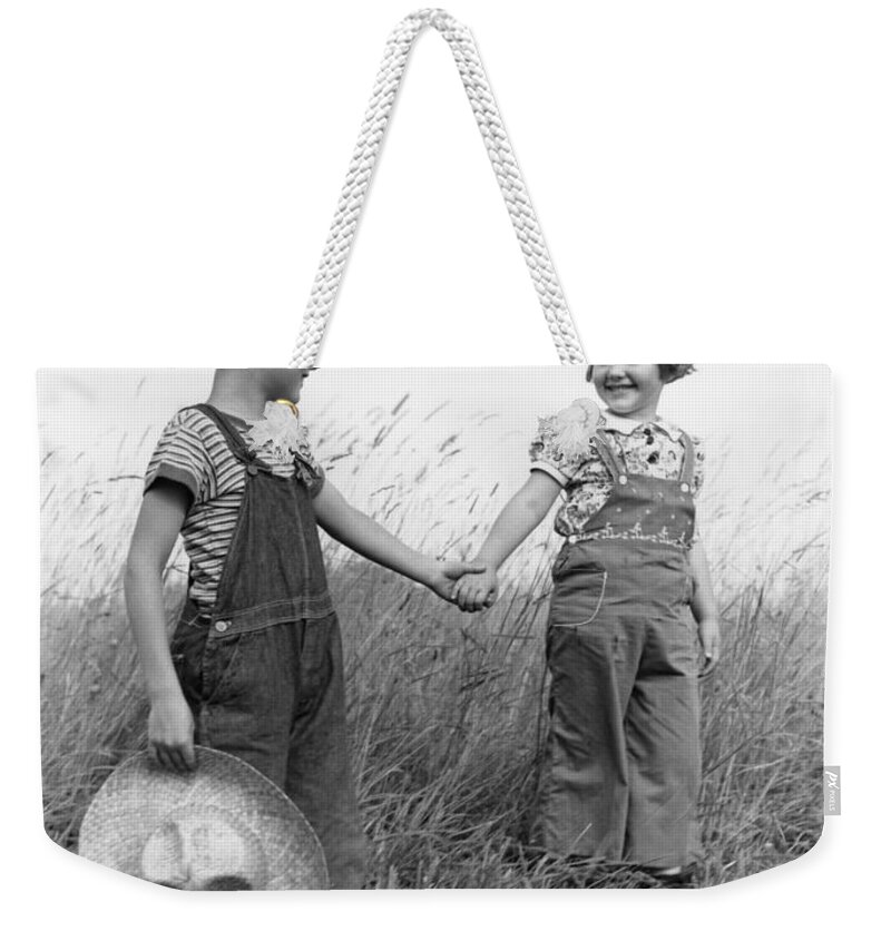 1930s Weekender Tote Bag featuring the photograph Farm Kids Holding Hands, C.1930-40s by H. Armstrong Roberts/ClassicStock