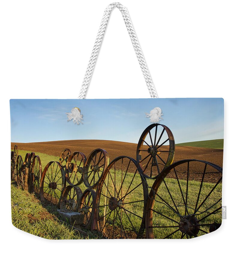 Palouse Weekender Tote Bag featuring the photograph Fence of Wheels by Mary Lee Dereske