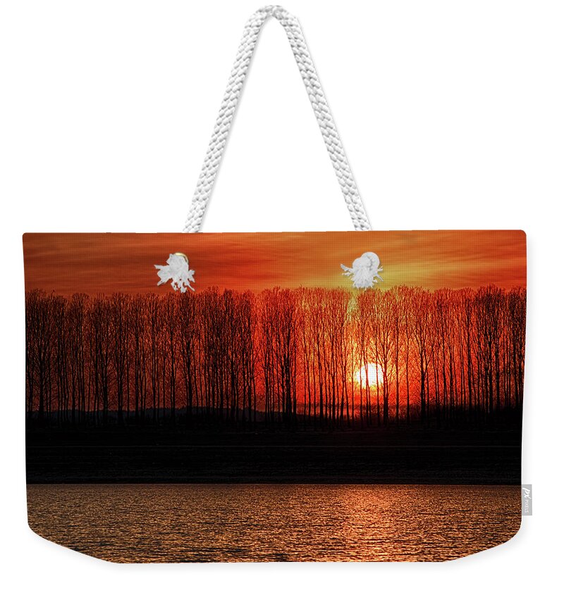 Trees Weekender Tote Bag featuring the photograph Fiery sunset by Plamen Petkov