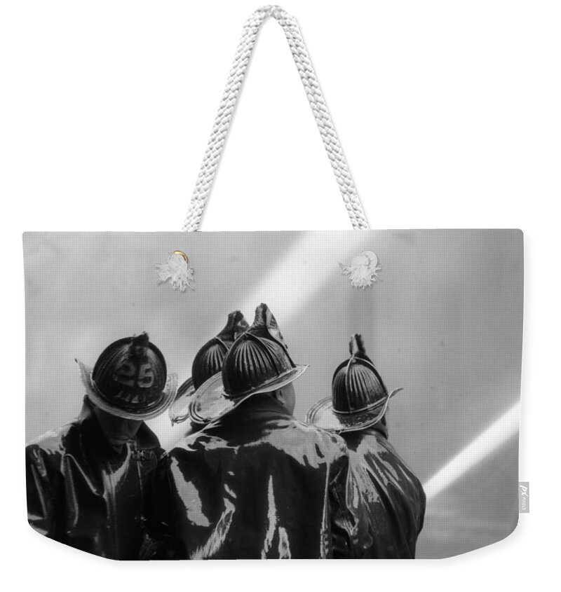 1920s Weekender Tote Bag featuring the photograph Firemen Aiming Hoses At Blaze, C.1920s by H. Armstrong Roberts/ClassicStock