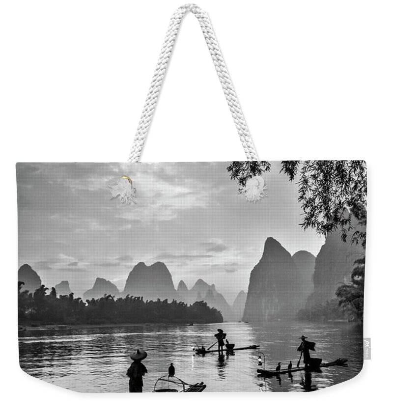 China Weekender Tote Bag featuring the photograph Fishermen at dawn. by Usha Peddamatham