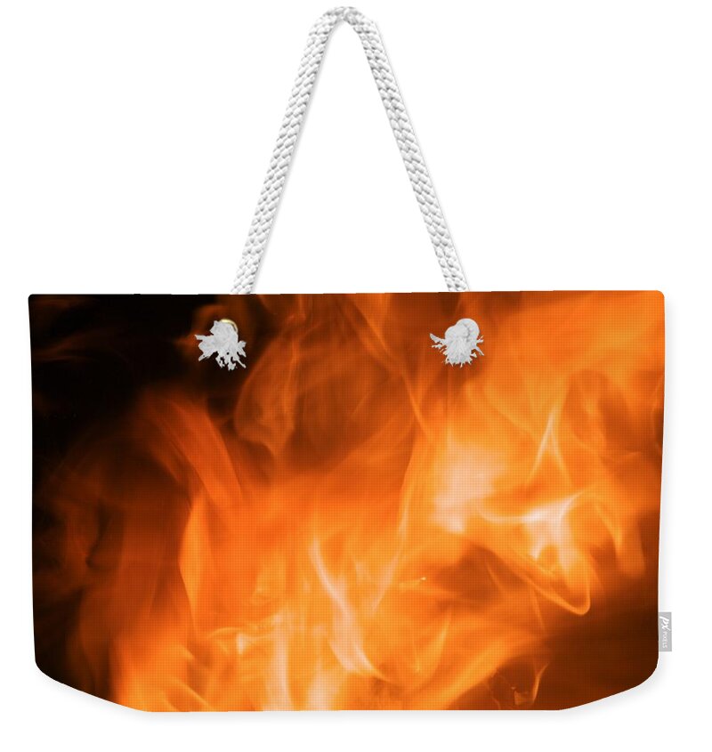Flames Weekender Tote Bag featuring the photograph Flaming hot by Christopher Rowlands