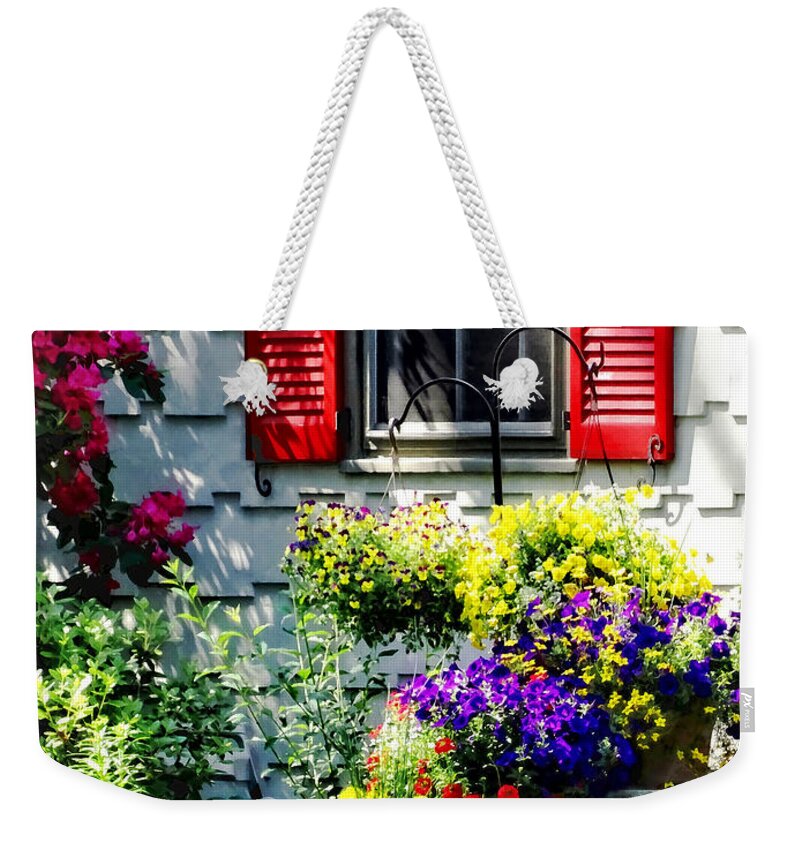 Shutters Weekender Tote Bag featuring the photograph Flowers and Red Shutters by Susan Savad
