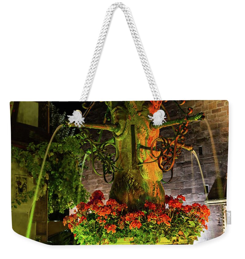 Old Fountain Weekender Tote Bag featuring the photograph Fountain of Kaysersberg by night by Paul MAURICE