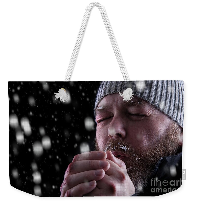 Snow Weekender Tote Bag featuring the photograph Freezing cold man in snow storm by Simon Bratt