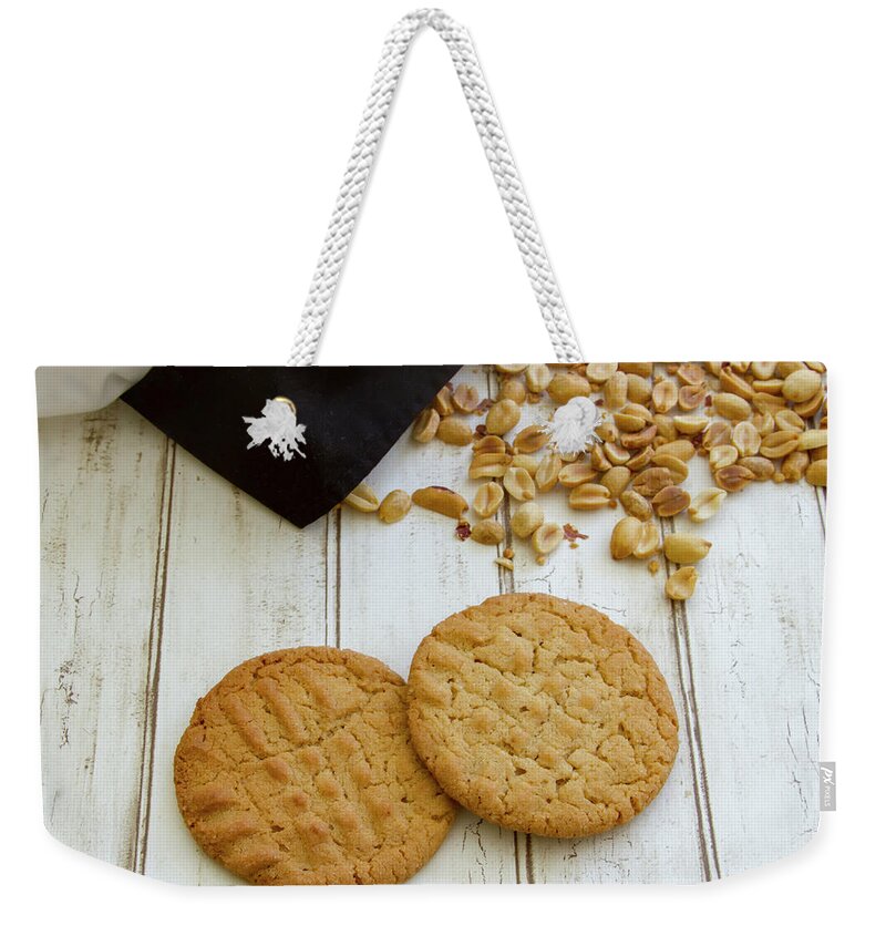 Baked Weekender Tote Bag featuring the photograph Fresh baked peanut butter cookies with chefs hat by Karen Foley