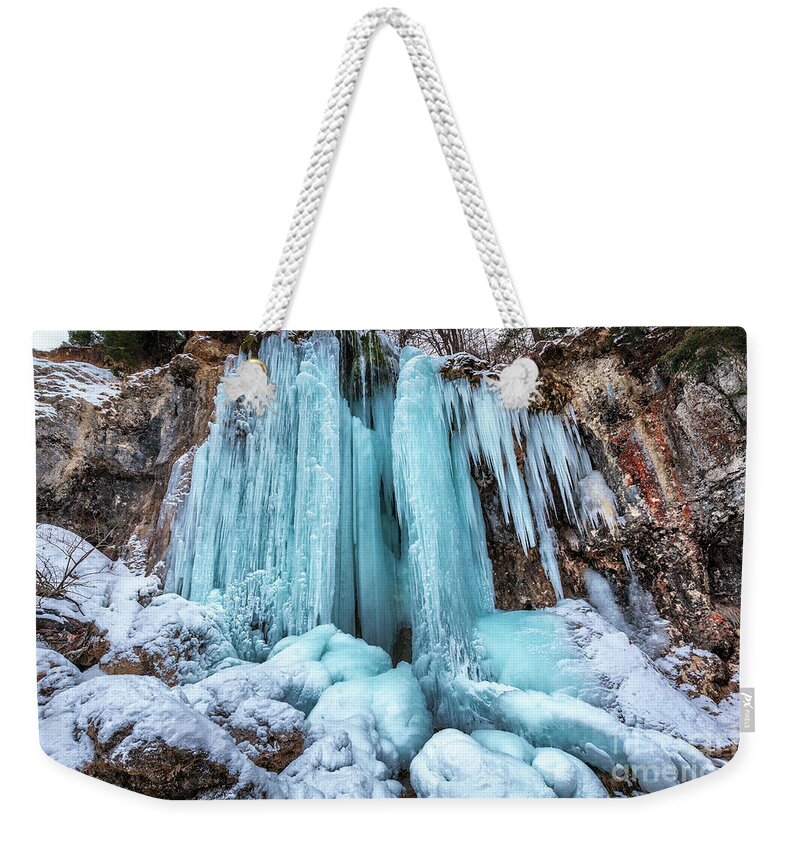 Winter Weekender Tote Bag featuring the photograph Frozen waterfall in the winter by Ragnar Lothbrok