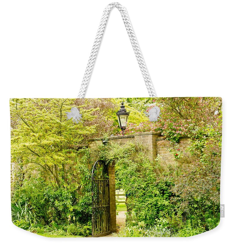 Garden Wall Weekender Tote Bag featuring the photograph Garden Wall With Iron Gate And Lantern. by Elena Perelman