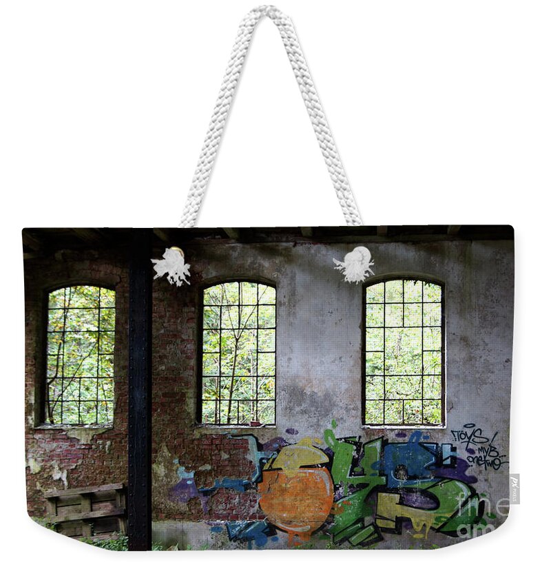 Factory Weekender Tote Bag featuring the photograph Graffiti on the walls of an old factory by Eva-Maria Di Bella