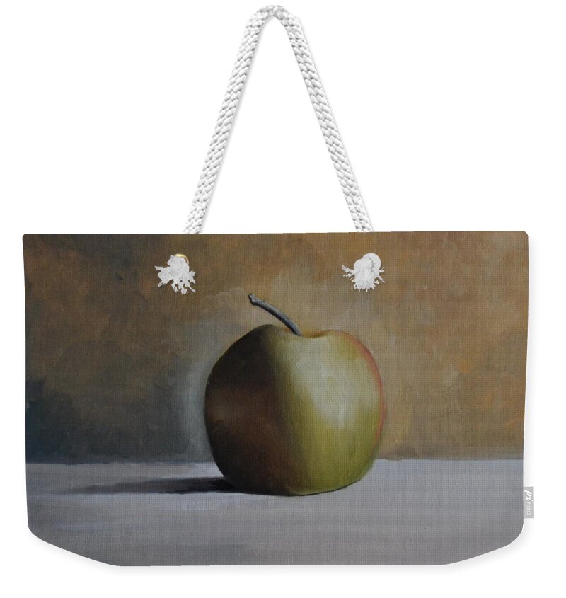 A Green Apple Sitting On A Light Gray Table. The Apple Has A Stem And Is Casting A Dark Shadow On The Table. The Background Is Multi-colors Of Gray Weekender Tote Bag featuring the painting Green Apple by Martin Schmidt