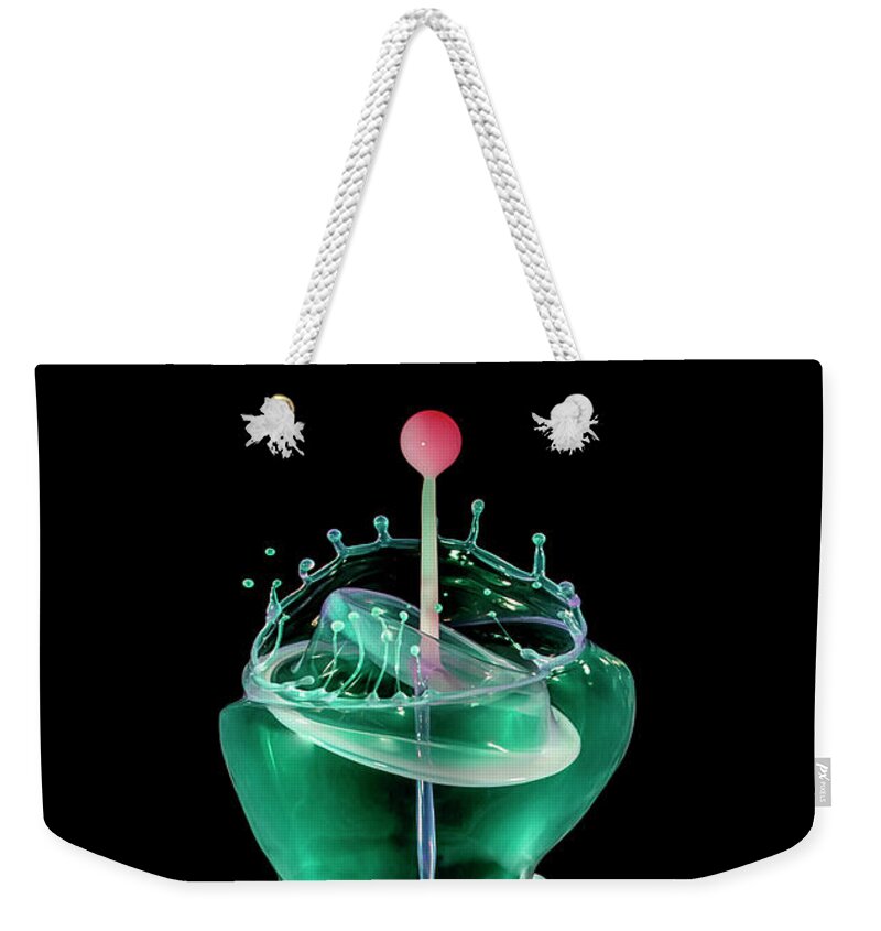 Waterdrop Weekender Tote Bag featuring the photograph Green liquid scuplture by Jaroslaw Blaminsky