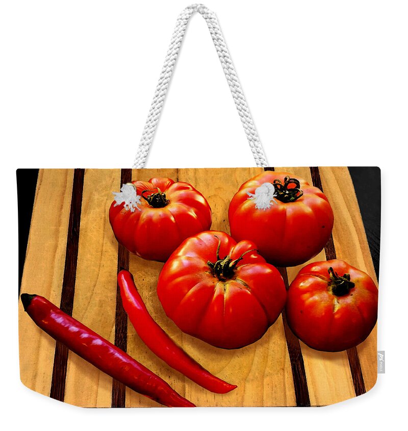 Tomato Weekender Tote Bag featuring the photograph Heirloom Tomatoes by Susan Vineyard