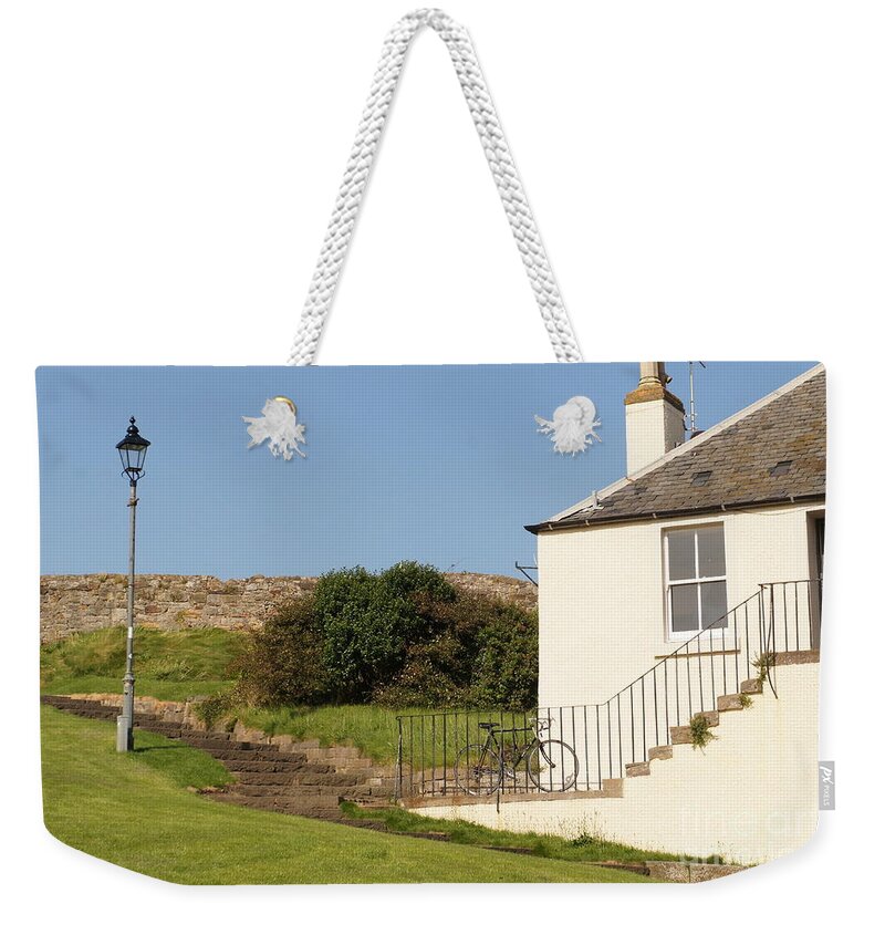 House On The Slope Weekender Tote Bag featuring the photograph House on the slope with a bike and a lamppost. by Elena Perelman
