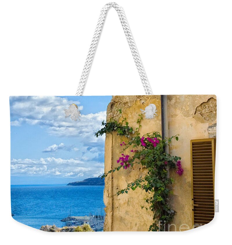 Architecture Weekender Tote Bag featuring the photograph House with bougainvillea street lamp and distant sea by Silvia Ganora