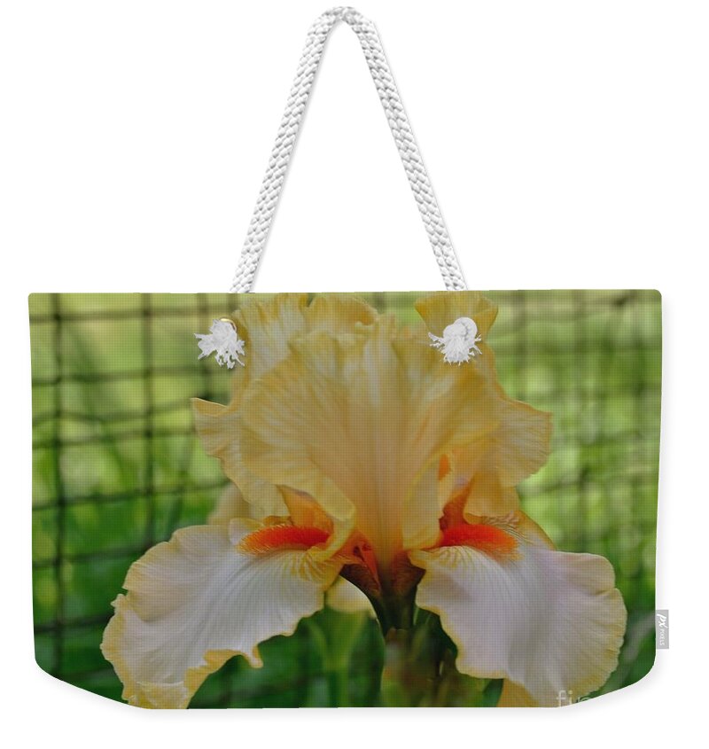 Photo Weekender Tote Bag featuring the photograph Iris By The Fence by Marsha Heiken