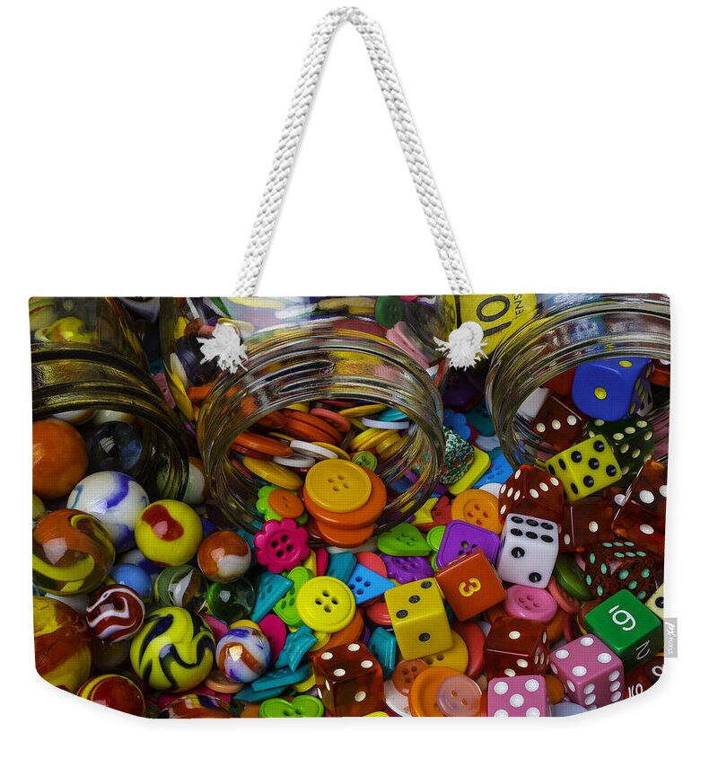 Three Weekender Tote Bag featuring the photograph Jars Pouring Out Marbles Buttond Dice by Garry Gay