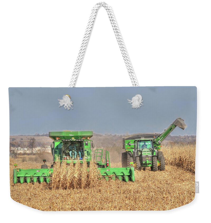 John Deere Weekender Tote Bag featuring the photograph John Deere Combine Picking Corn Followed By Tractor And Grain Cart by J Laughlin