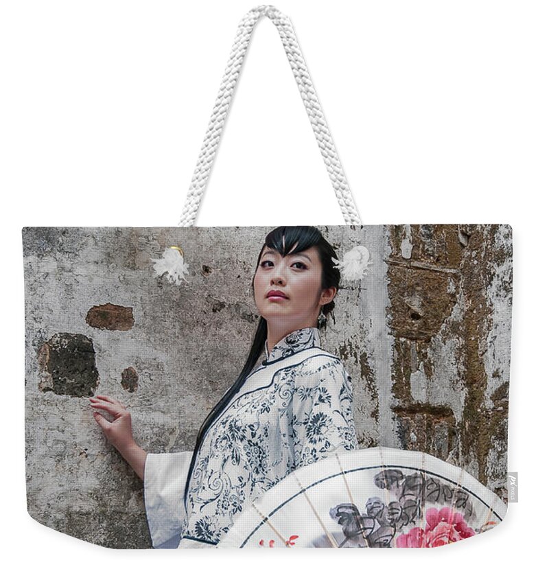 Asia Weekender Tote Bag featuring the photograph Lady with an umbrella. by Usha Peddamatham
