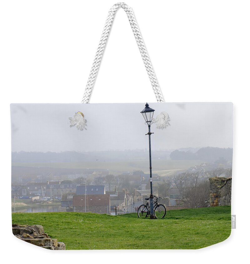 Lamppost Weekender Tote Bag featuring the photograph Lamppost and bike. by Elena Perelman