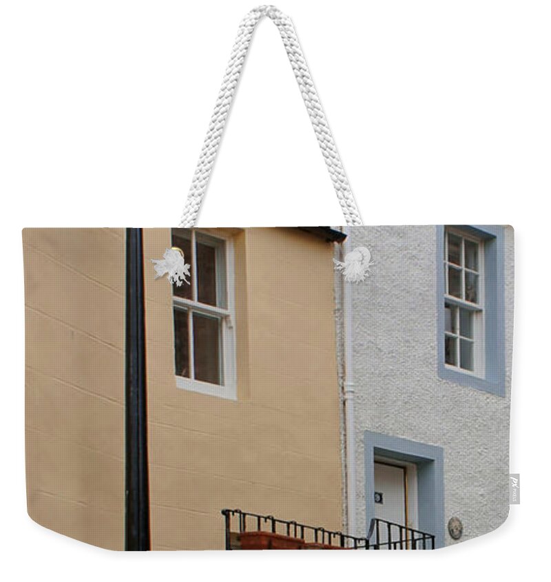 Lamppost Weekender Tote Bag featuring the photograph Lamppost on narrow street by Elena Perelman
