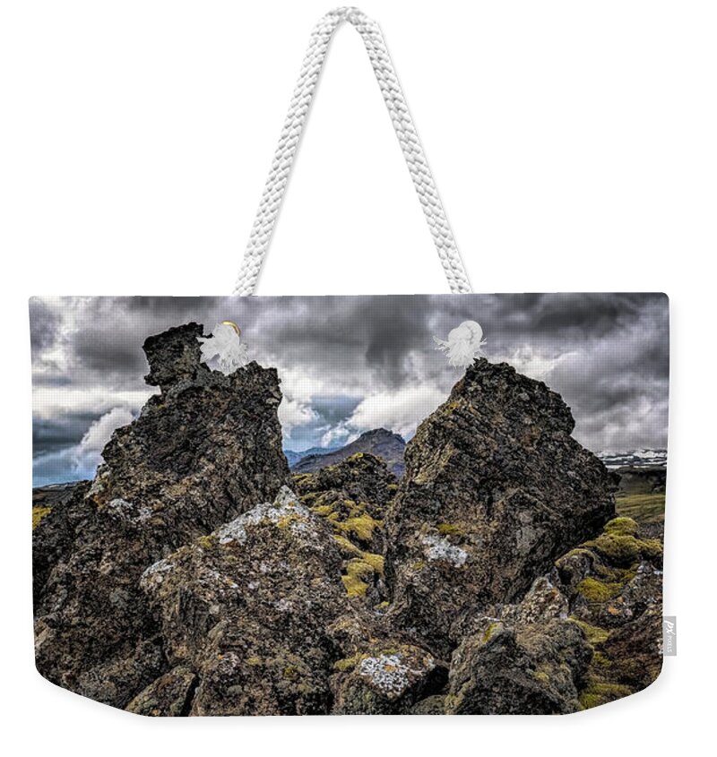 Iceland Weekender Tote Bag featuring the photograph Lava Rock And Clouds by Tom Singleton