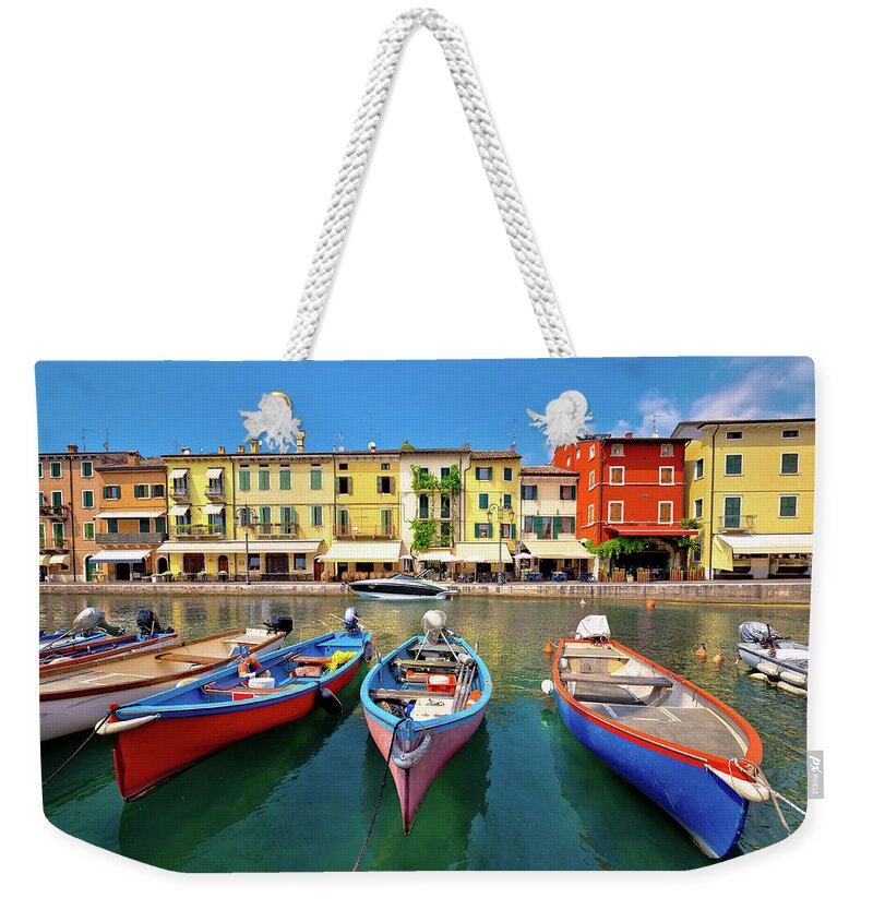 Lazise Weekender Tote Bag featuring the photograph Lazise colorful harbor and boats view by Brch Photography
