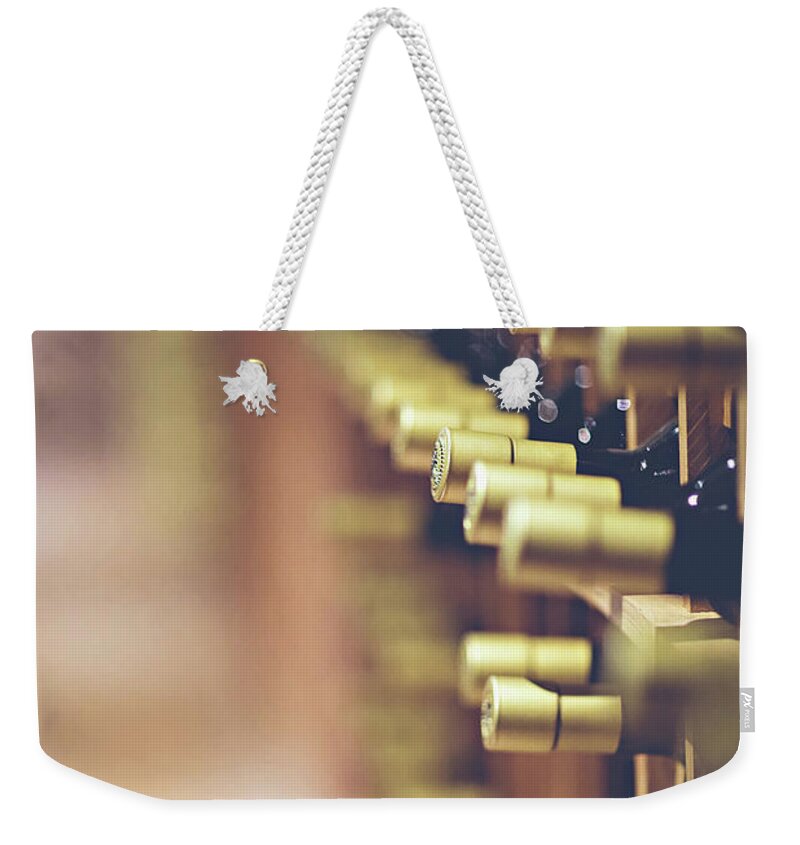 Room; Cellar; Many; Collection; Pantry; Beverage; Drink; Drinking; Alcohol; Alcoholic; Cork; Corks; Liquid; Macro; Blur; Blurred; Bottles; Food And Wine; Still Life; Object; Objects; Pattern; Compartments; Lighting Weekender Tote Bag featuring the photograph Let's Crack One Open by Trish Mistric