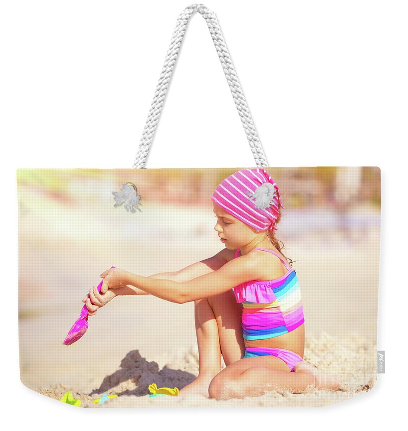 Active Weekender Tote Bag featuring the photograph Little girl playing on the beach by Anna Om