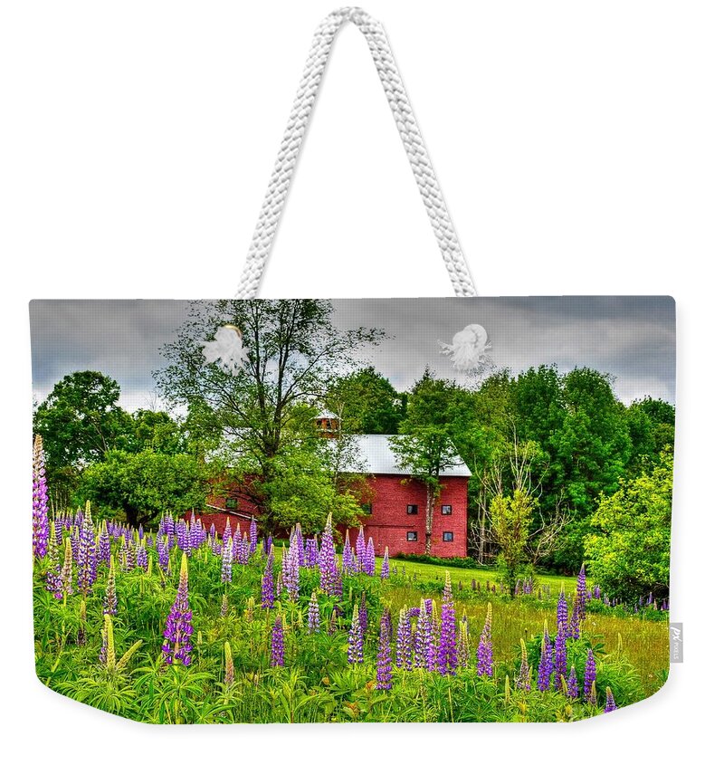 Sugar Hill Weekender Tote Bag featuring the photograph Lupines and the Red Barn by Steve Brown