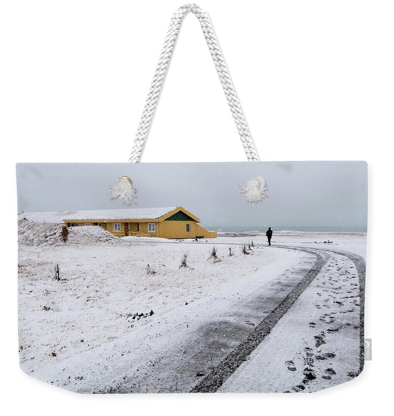 Iceland Weekender Tote Bag featuring the photograph Man walking in snow Iceland by Michalakis Ppalis
