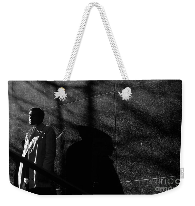 Man Weekender Tote Bag featuring the photograph Man with flower by Jim Corwin