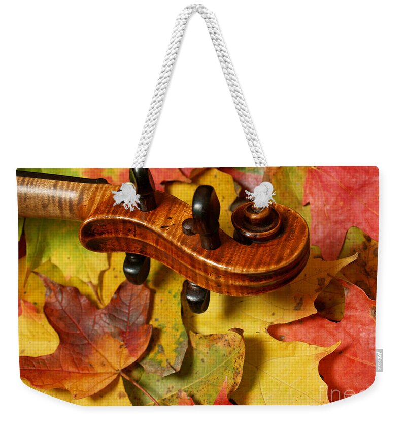 Violin Weekender Tote Bag featuring the photograph Maple Violin Scroll on Fall Maple Leaves by Anna Lisa Yoder
