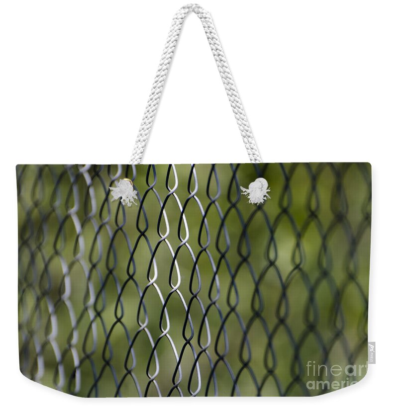 Fence Weekender Tote Bag featuring the photograph Metal fence by Mats Silvan