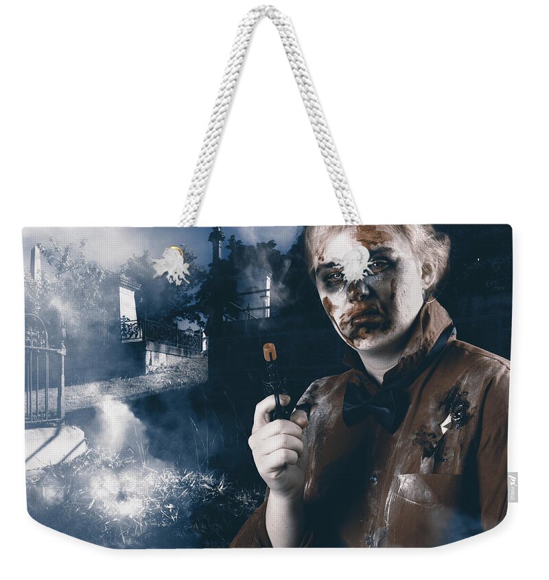 Haunted Weekender Tote Bag featuring the photograph Monster in cemetery holding gun. Grave robber by Jorgo Photography