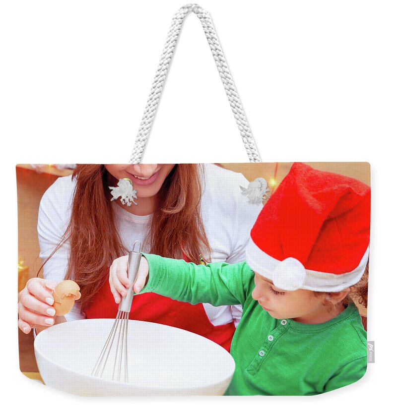 Baby Weekender Tote Bag featuring the photograph Mother with son baking Christmas cookies by Anna Om