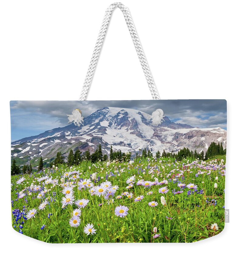Alpine Weekender Tote Bag featuring the photograph Mount Rainier and a Meadow of Aster by Jeff Goulden
