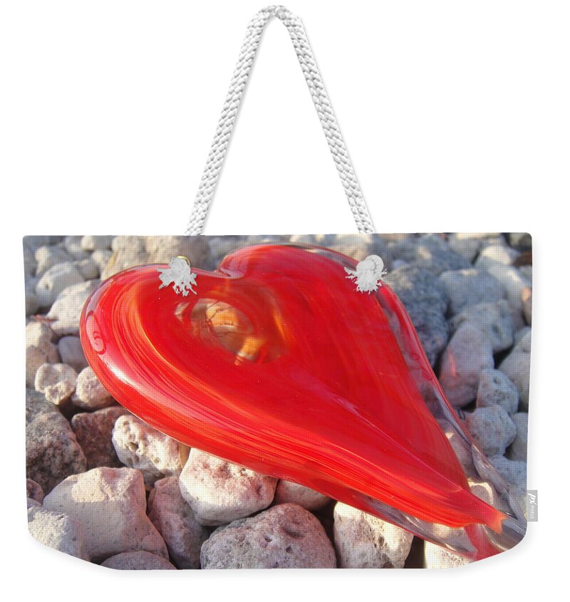 Glass Heart Weekender Tote Bag featuring the photograph My hearts on the rocks by WaLdEmAr BoRrErO