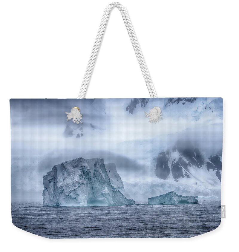 Mystical Weekender Tote Bag featuring the photograph Mystical Morning Icebergs by John Haldane