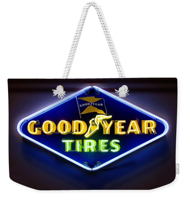 Transportation Weekender Tote Bag featuring the photograph Neon Goodyear Tires Sign by Mike McGlothlen