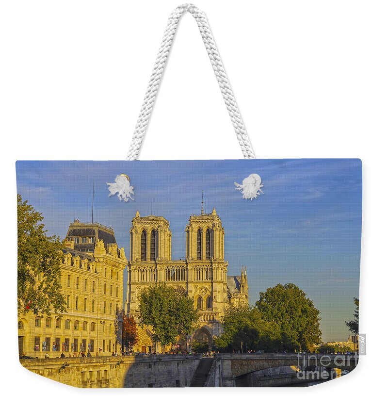 Dame Weekender Tote Bag featuring the photograph Notre Dame at sunset by Patricia Hofmeester