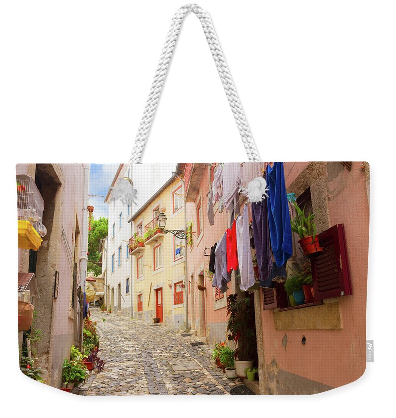 Lisbon Weekender Tote Bag featuring the photograph Old Street of Lisbon by Anastasy Yarmolovich