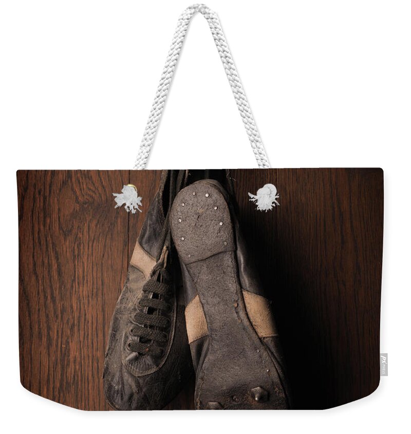 Football Weekender Tote Bag featuring the photograph Old used sports shoes by Andreas Berheide