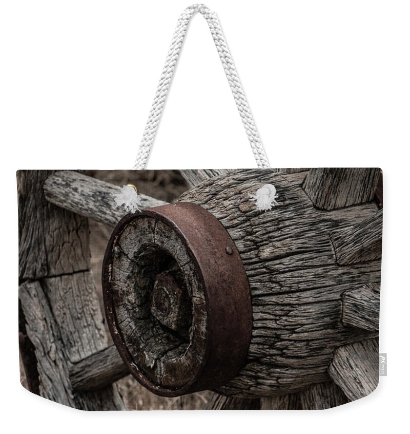 Aged Weekender Tote Bag featuring the photograph Old Wagon Wheel by Teresa Wilson
